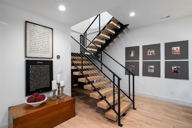 staircase featuring hardwood / wood-style flooring