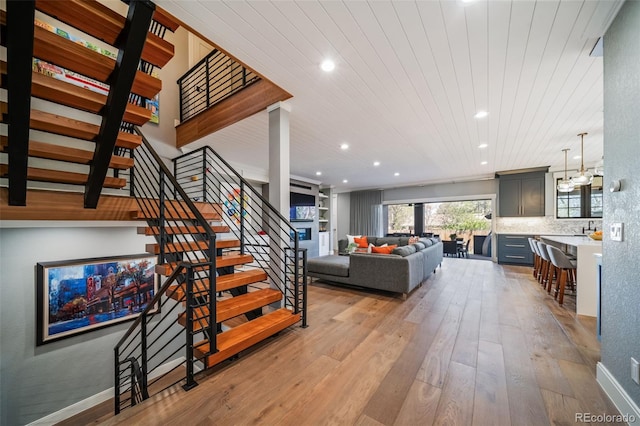 living area with recessed lighting, wooden ceiling, stairway, and hardwood / wood-style flooring