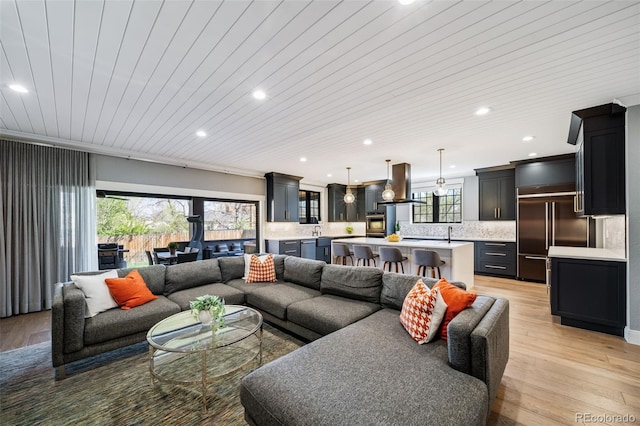 living room featuring recessed lighting, ornamental molding, light wood finished floors, and wooden ceiling