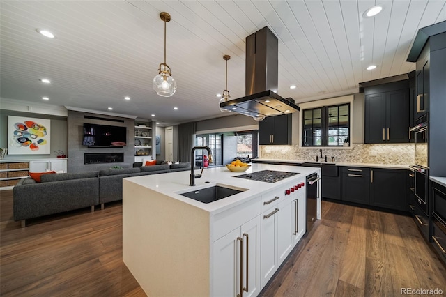 kitchen featuring white gas cooktop, a sink, a wealth of natural light, and island exhaust hood