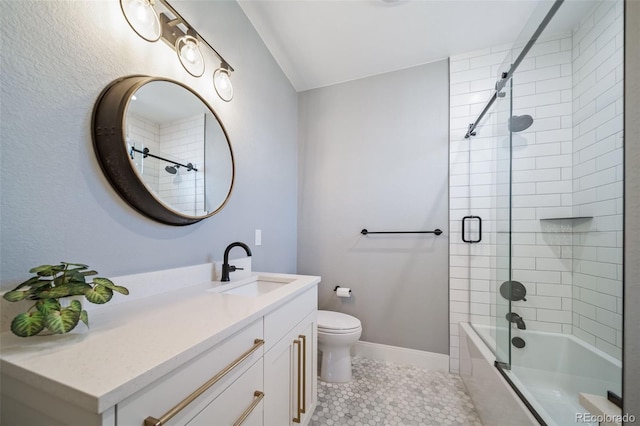 bathroom with vanity, toilet, tile patterned floors, enclosed tub / shower combo, and baseboards