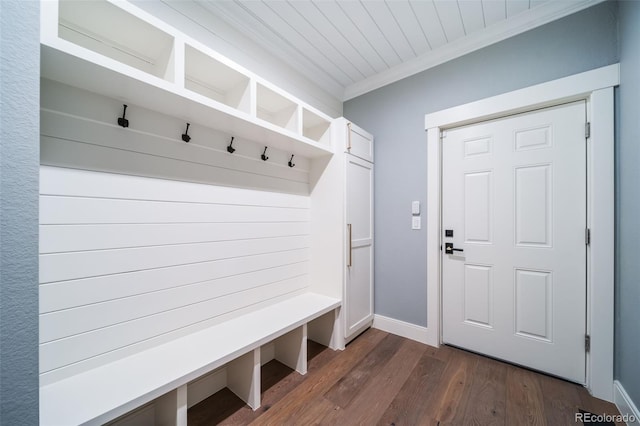 mudroom with crown molding, baseboards, and dark wood-style floors
