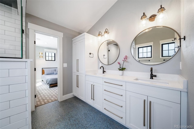 full bathroom with a sink and double vanity