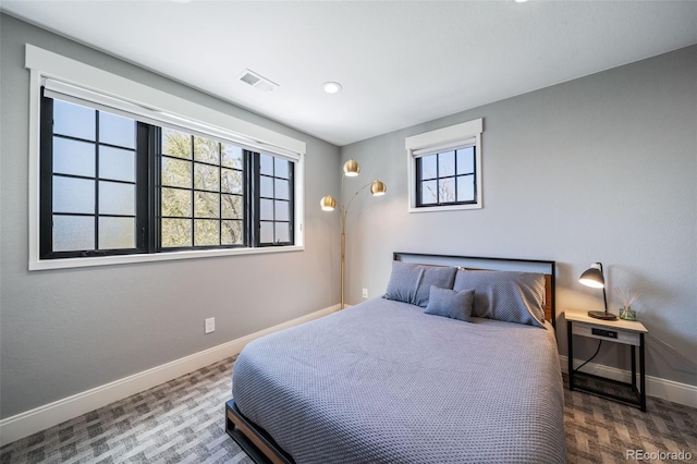 bedroom featuring baseboards, recessed lighting, wood finished floors, and visible vents