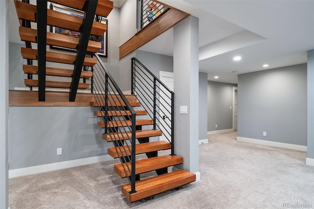 staircase featuring baseboards, carpet, and recessed lighting