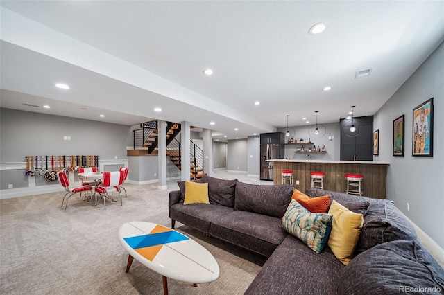 living area with visible vents, stairs, light carpet, recessed lighting, and wet bar