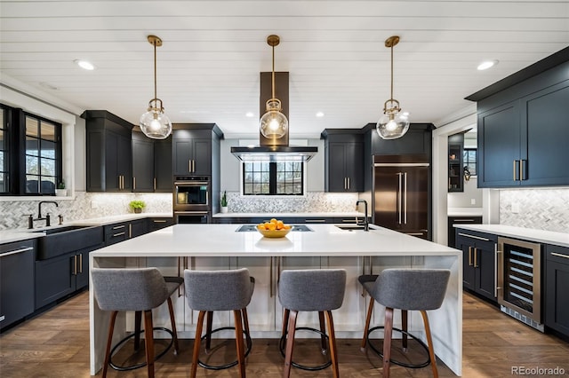 2732 S Jackson St, Denver, CO 80210 - kitchen with beverage cooler, built in refrigerator, backsplash, an island with sink, and a sink