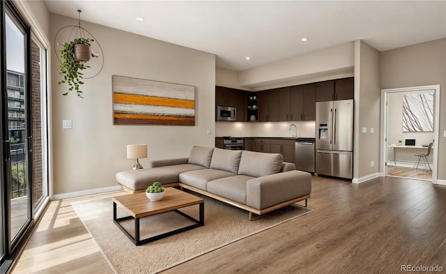 1643 Boulder St Unit 211, Denver, CO 80211 - living room with recessed lighting, wood finished floors, and baseboards