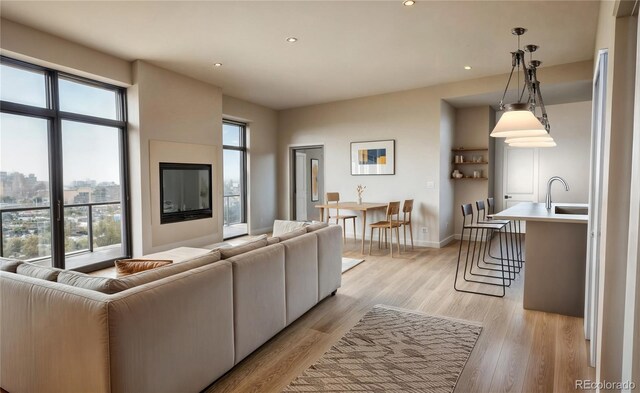 1643 Boulder St Unit 211, Denver, CO 80211 - living area with baseboards, a wealth of natural light, light wood finished floors, and recessed lighting