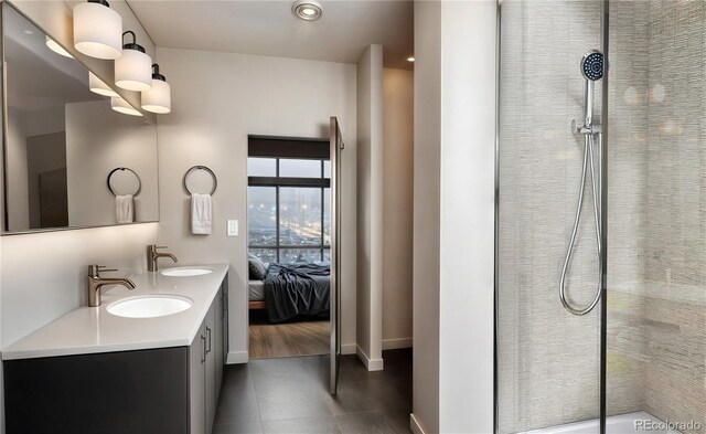 1643 Boulder St Unit 211, Denver, CO 80211 - bathroom featuring double vanity, baseboards, tiled shower, and a sink