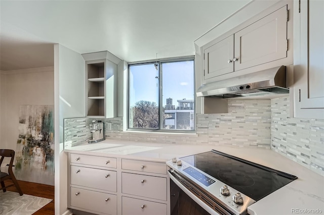 kitchen featuring exhaust hood, light countertops, stainless steel electric range, decorative backsplash, and open shelves