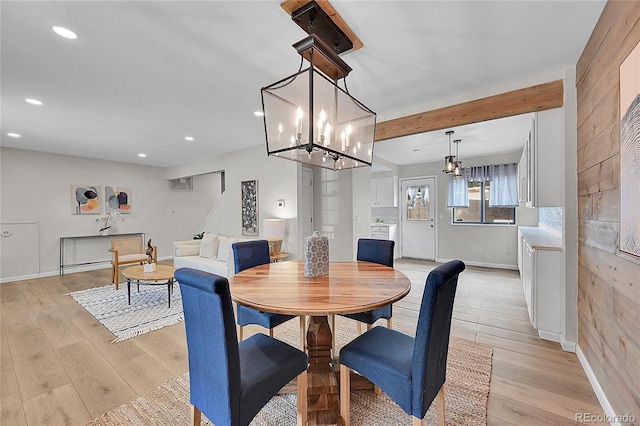 dining room with recessed lighting, baseboards, and light wood finished floors