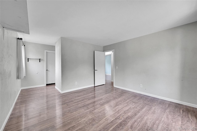 interior space with baseboards and wood finished floors