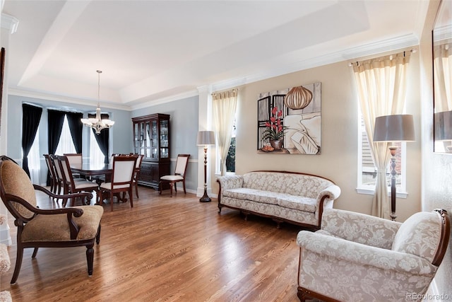 2959 W 110th Pl, Westminster, CO 80234 - living room featuring a raised ceiling, a chandelier, wood finished floors, ornamental molding, and baseboards
