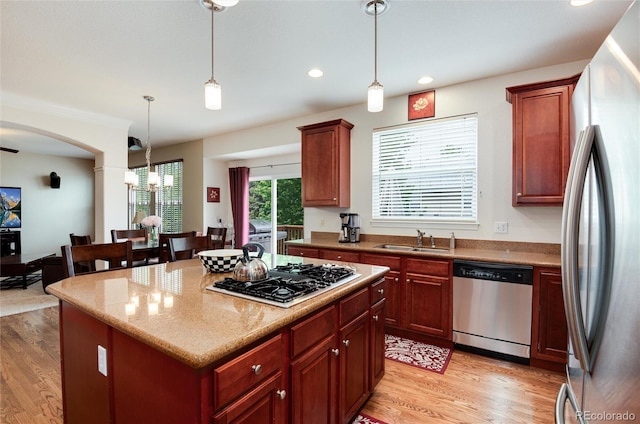 2959 W 110th Pl, Westminster, CO 80234 - kitchen with appliances with stainless steel finishes, a sink, light wood-style floors, decorative light fixtures, and recessed lighting