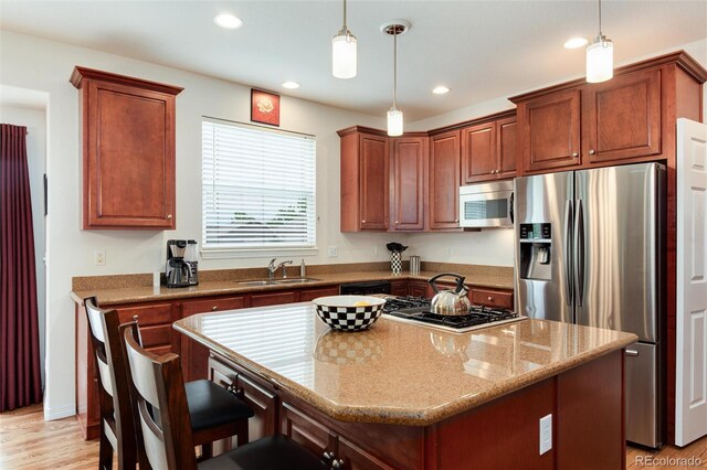 2959 W 110th Pl, Westminster, CO 80234 - kitchen featuring stainless steel appliances, a sink, light wood-style floors, recessed lighting, and hanging light fixtures