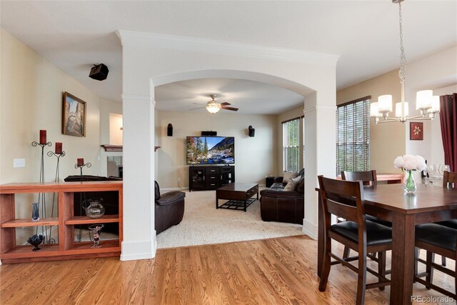 2959 W 110th Pl, Westminster, CO 80234 - dining room with arched walkways, wood finished floors, a chandelier, ceiling fan, and baseboards