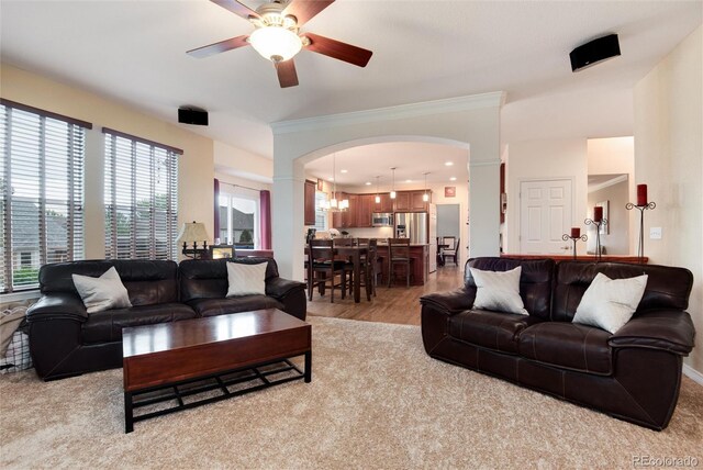2959 W 110th Pl, Westminster, CO 80234 - living area with decorative columns, ceiling fan, arched walkways, ornamental molding, and light wood finished floors