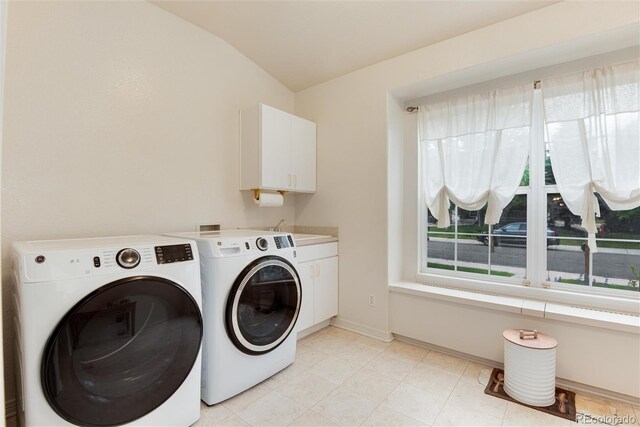 2959 W 110th Pl, Westminster, CO 80234 - laundry area with washer and clothes dryer, cabinet space, baseboards, and light tile patterned flooring