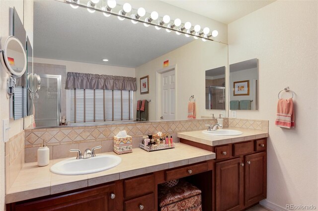 2959 W 110th Pl, Westminster, CO 80234 - bathroom with decorative backsplash, a stall shower, and double vanity