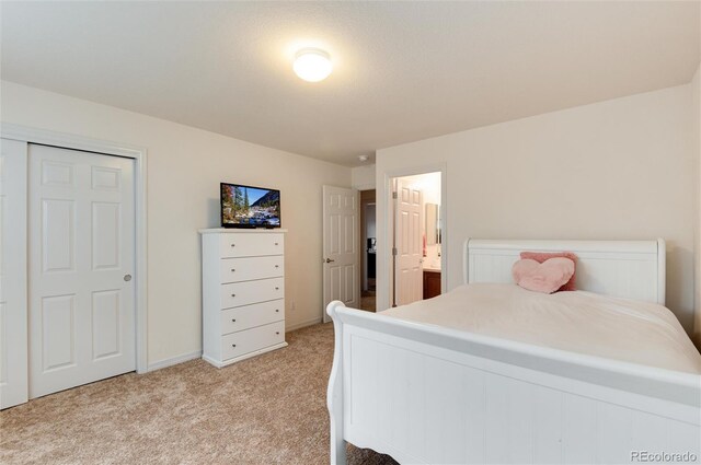 2959 W 110th Pl, Westminster, CO 80234 - bedroom featuring light carpet, baseboards, and ensuite bathroom