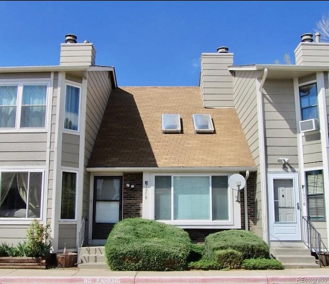 view of front of home featuring a chimney and cooling unit