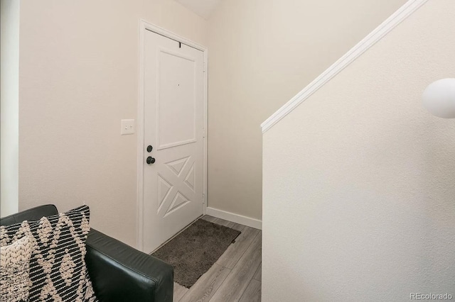 interior space featuring baseboards and wood finished floors