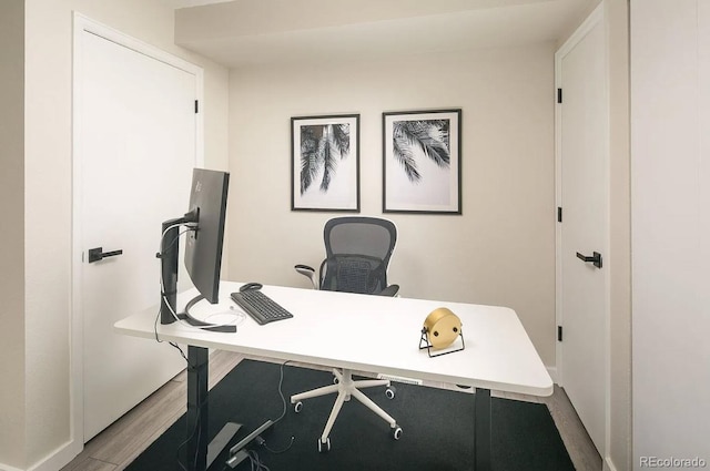 office area featuring light wood-style flooring and baseboards