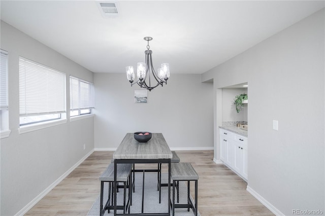 dining room featuring a chandelier and light hardwood / wood-style floors