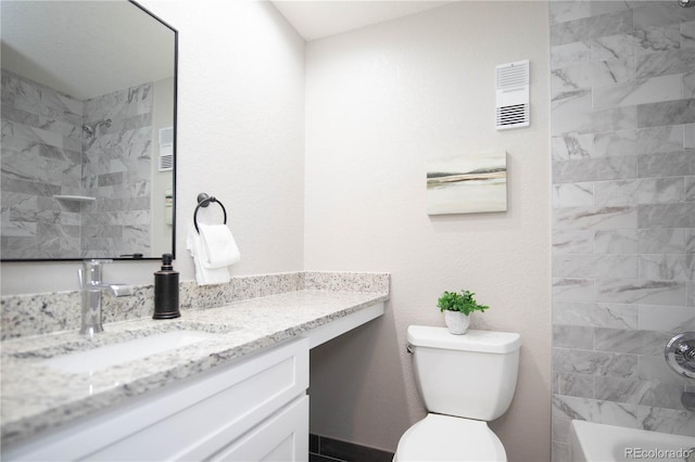 full bathroom with vanity, toilet, and tiled shower / bath combo