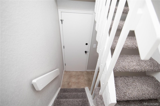 staircase with tile patterned flooring