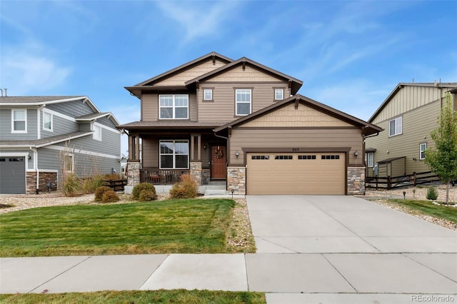 craftsman inspired home with covered porch, a garage, and a front lawn