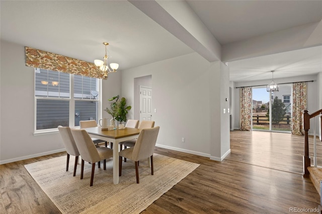 dining space featuring beamed ceiling, hardwood / wood-style floors, and a notable chandelier