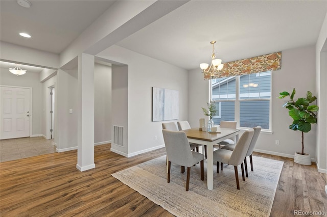 dining room featuring hardwood / wood-style floors and a notable chandelier