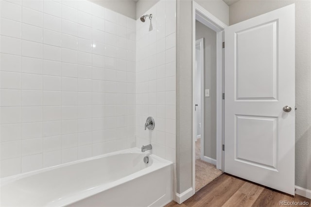 bathroom featuring hardwood / wood-style floors and tiled shower / bath