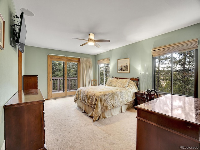 bedroom with light carpet, access to exterior, and ceiling fan