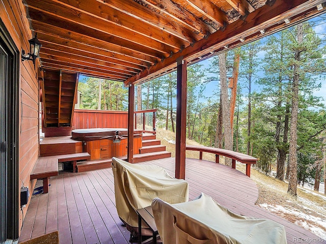 wooden deck with a hot tub