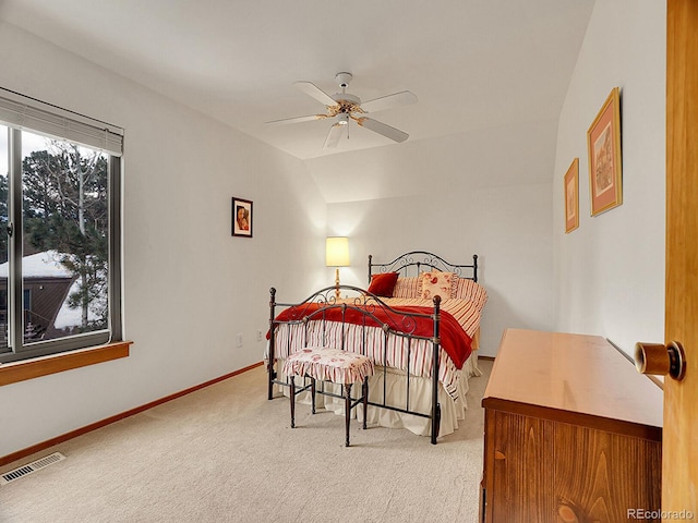 bedroom featuring ceiling fan, vaulted ceiling, and light colored carpet