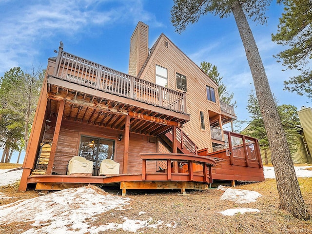 back of house with a balcony and a deck