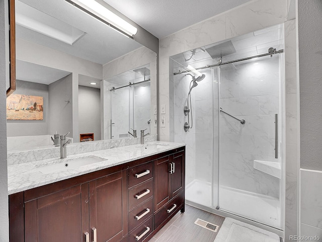 bathroom featuring vanity and a shower with shower door