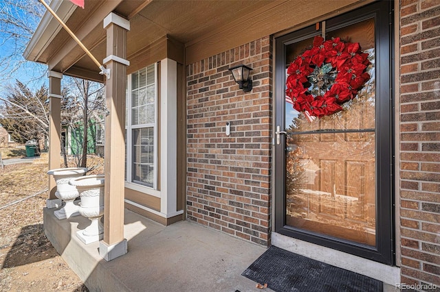 property entrance with brick siding