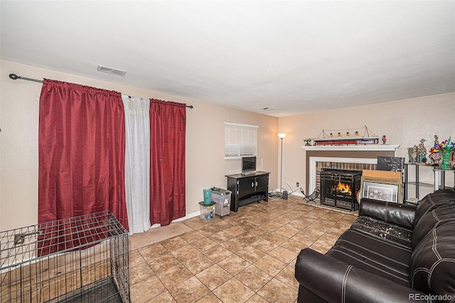 living room with a fireplace and visible vents