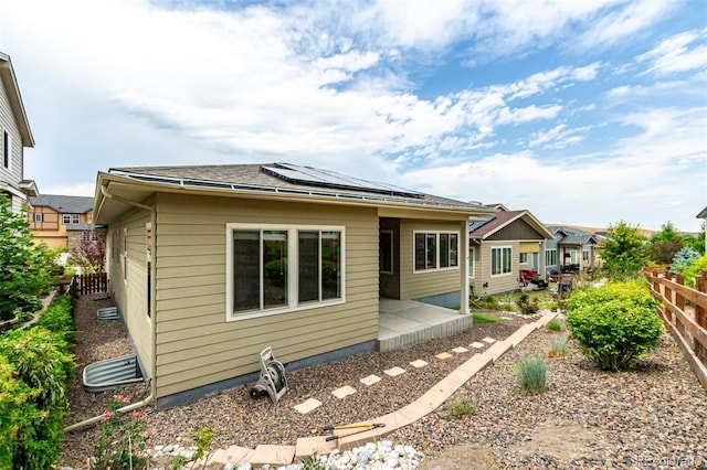 17490 W 94th Dr, Arvada, CO 80007 - back of property featuring roof mounted solar panels and a patio area