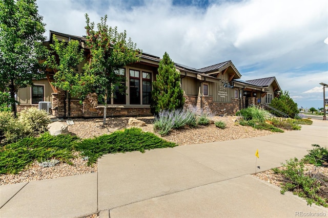 17490 W 94th Dr, Arvada, CO 80007 - view of front of property with stone siding, a standing seam roof, and a metal roof