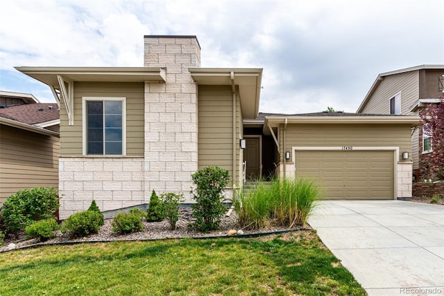 17490 W 94th Dr, Arvada, CO 80007 - view of front of home with driveway, an attached garage, a chimney, and a front lawn