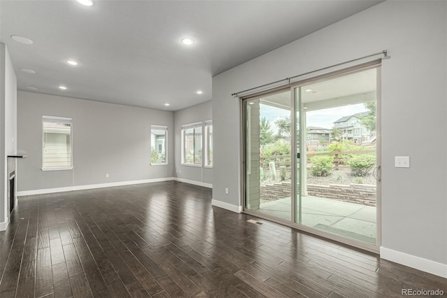 17490 W 94th Dr, Arvada, CO 80007 - unfurnished living room with dark wood finished floors and recessed lighting