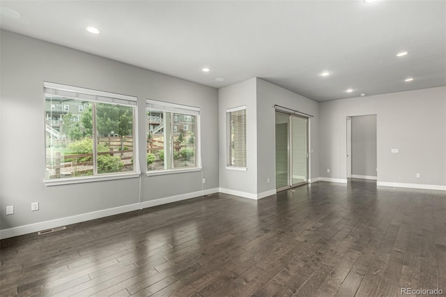 17490 W 94th Dr, Arvada, CO 80007 - spare room featuring dark wood-style flooring and recessed lighting