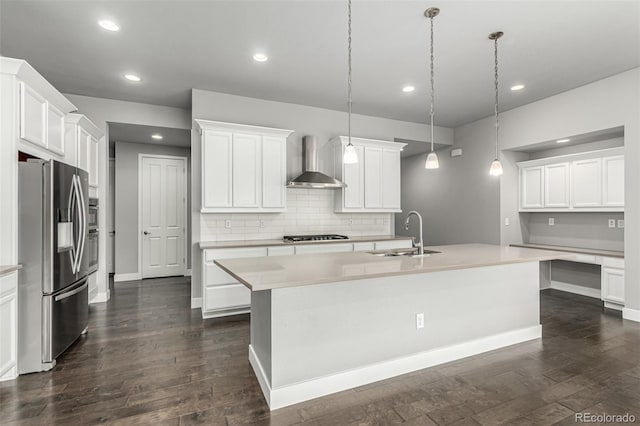 17490 W 94th Dr, Arvada, CO 80007 - kitchen with appliances with stainless steel finishes, wall chimney exhaust hood, an island with sink, dark wood-style floors, and recessed lighting