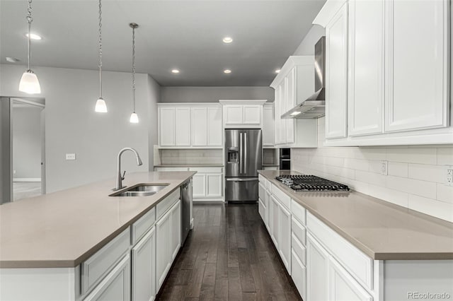 17490 W 94th Dr, Arvada, CO 80007 - kitchen featuring stainless steel appliances, wall chimney range hood, recessed lighting, dark wood finished floors, and backsplash