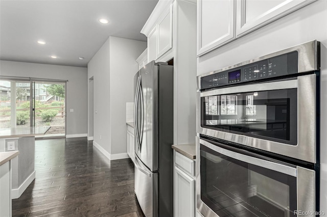 17490 W 94th Dr, Arvada, CO 80007 - kitchen with stainless steel appliances, white cabinets, recessed lighting, dark wood-style flooring, and light countertops